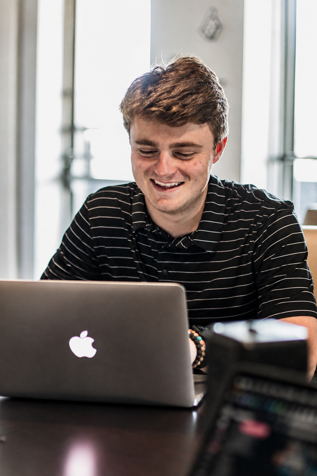 Luke Pauldine, founder of The Modern AI Company, working on a laptop